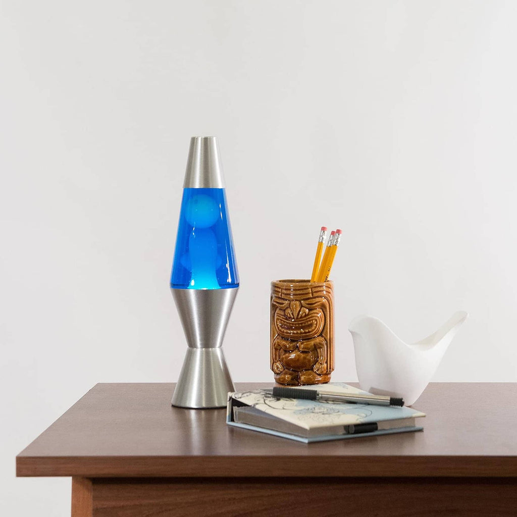 11.5" LAVA� Lamp - White/Blue/Silver on table with notebook and tiki mug
