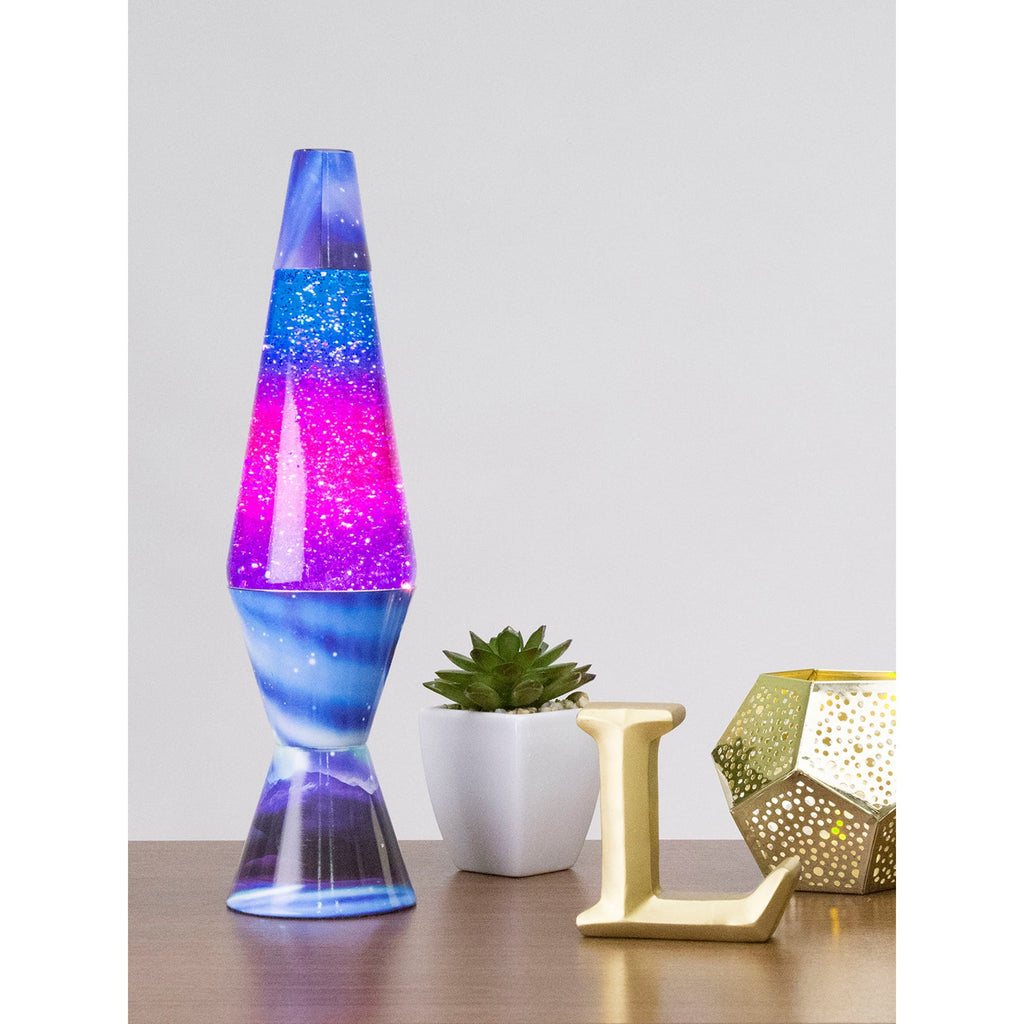 14.5" LAVA� Lamp Colormax Northern Lights - Glitter on a table with a succulent and a candle